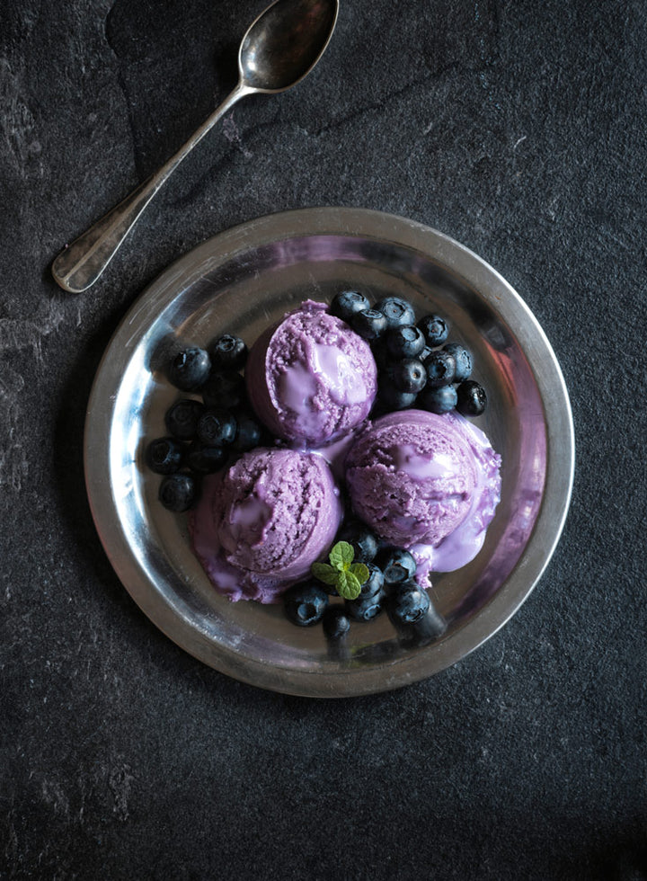 dairy-free blueberry ice cream on a silver plate with blueberries 