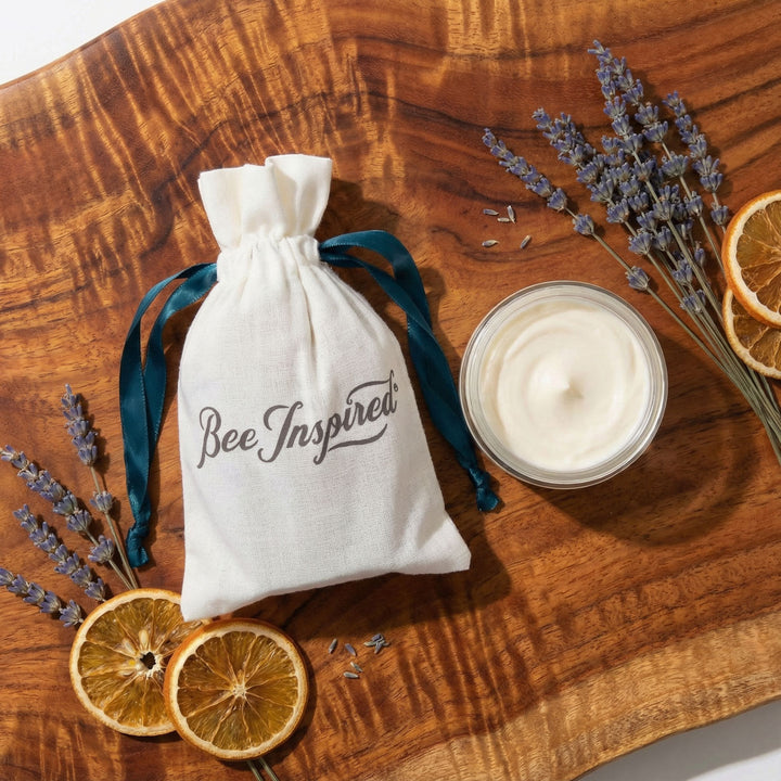 Bee Inspired cream party favor with lavender and dried lemon wheels on a wooden surface
