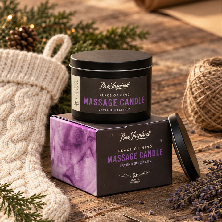 peace of mind massage candle holiday stocking and string and holiday greenery on wood surface