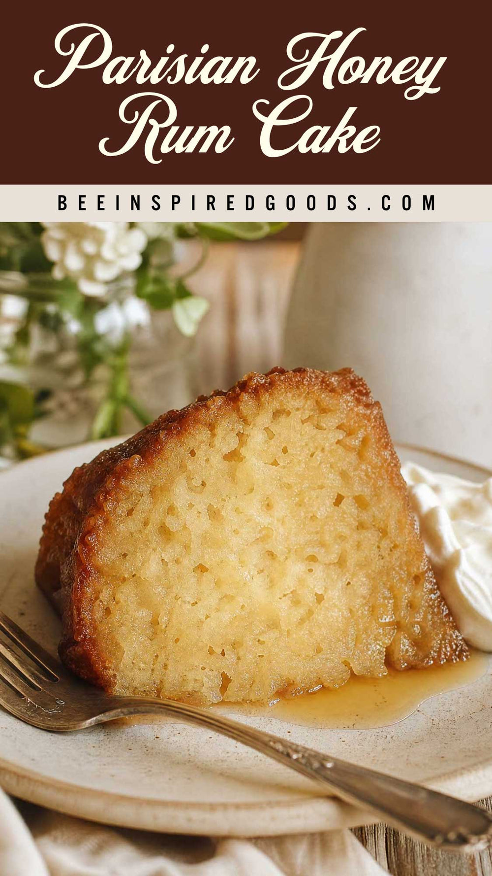 A slice of Parisian Honey Rum Cake on a plate with whipped cream and syrup, with a brown banner at the top reading 'Parisian Honey Rum Cake' and 'BEEINSPIREDGOODS.COM'.