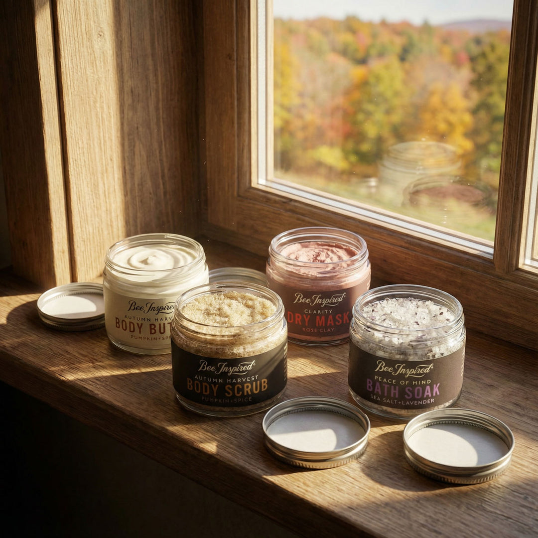 Jars of body products on a wooden surface with a window view of autumn foliage.