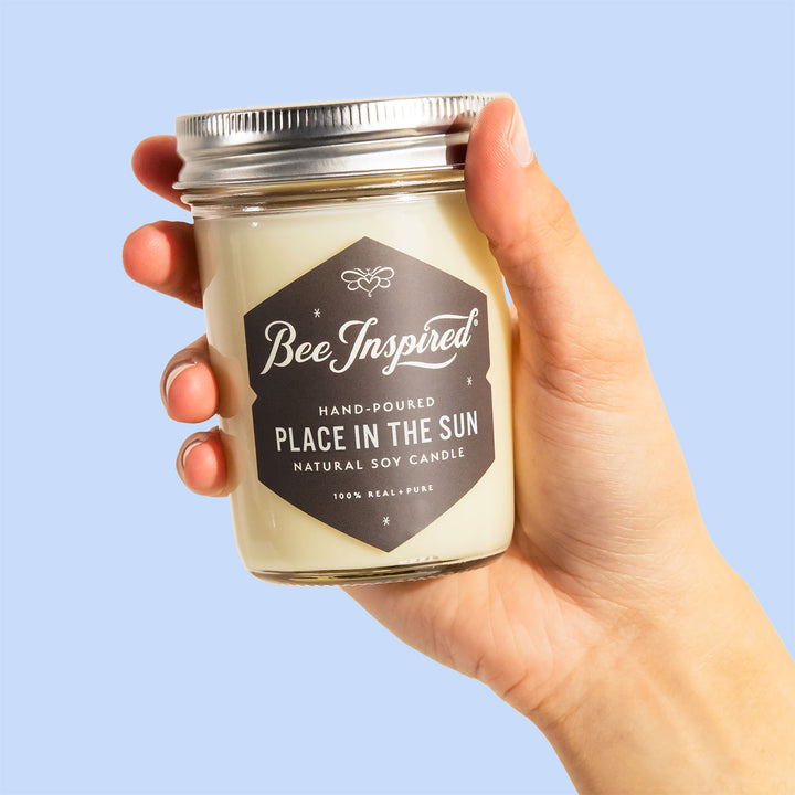 hand holding place in the sun soy candle