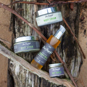 Sea+Tea body cream, scrub, body oil, and dry mask against driftwood