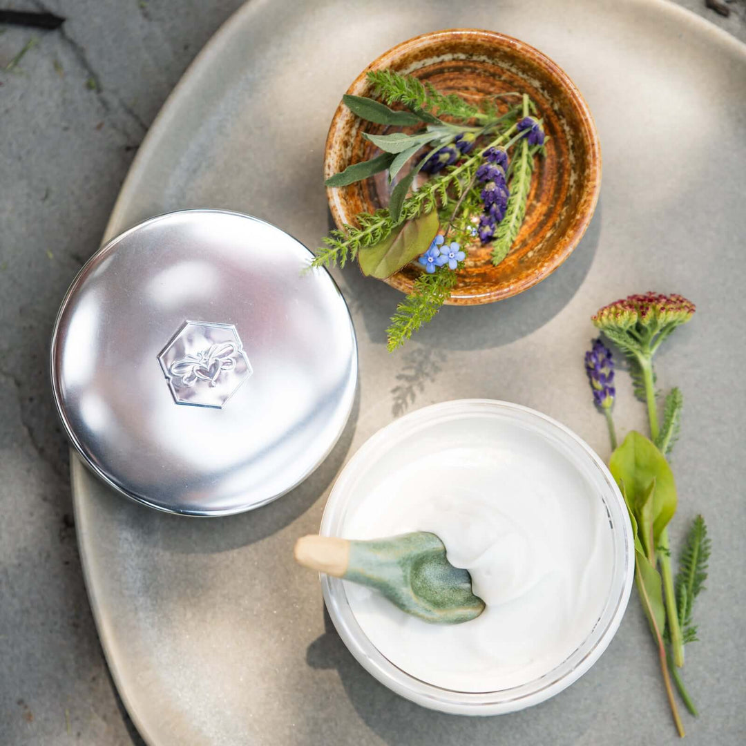 sea+tea cream from bee inspired honey retail store in owings mills on a plate with a small bowl full of greenery