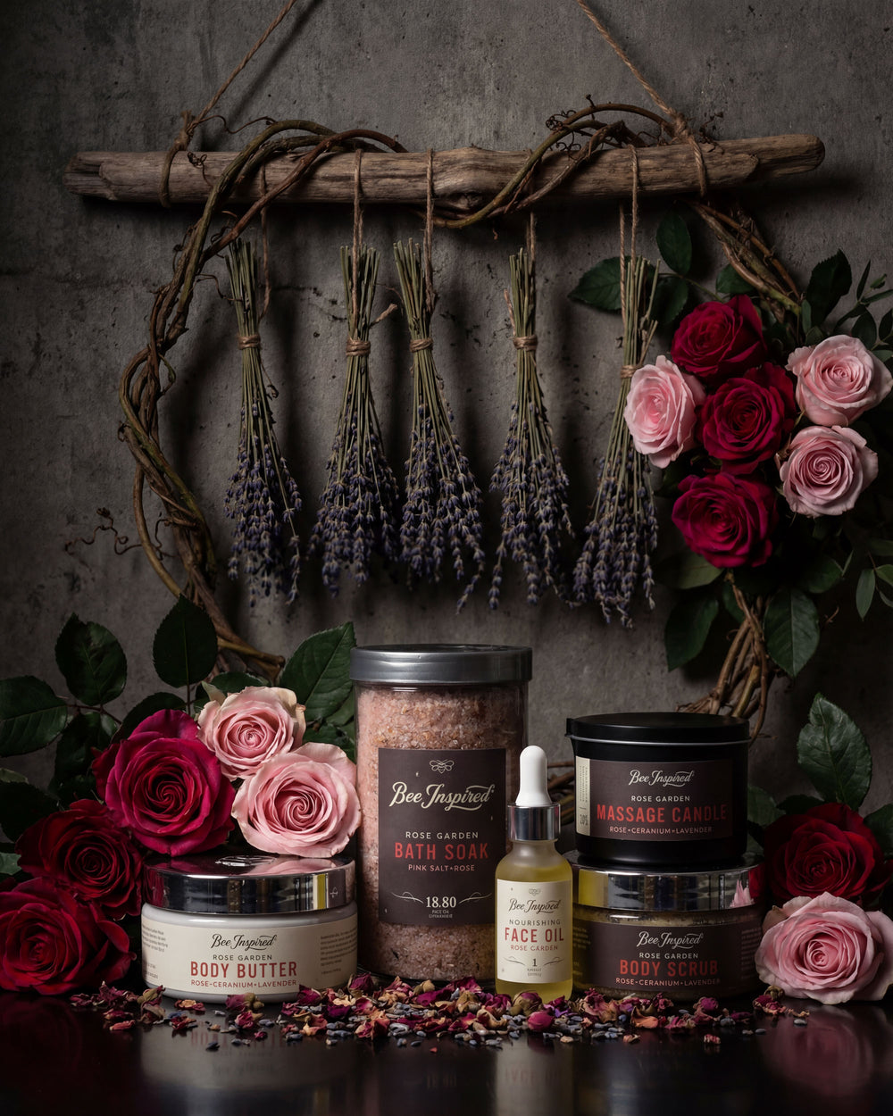 Collection of body care products with lavender and roses on a dark background