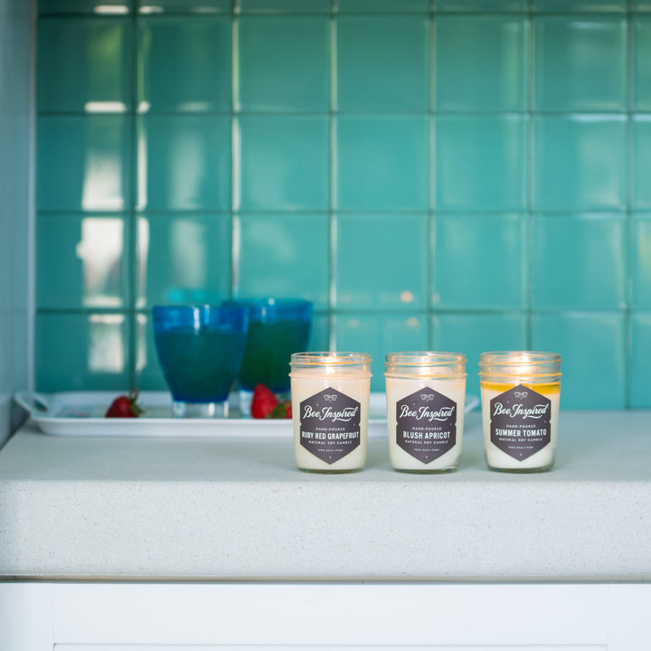 Summer jelly jar candle set burning in bathroom 