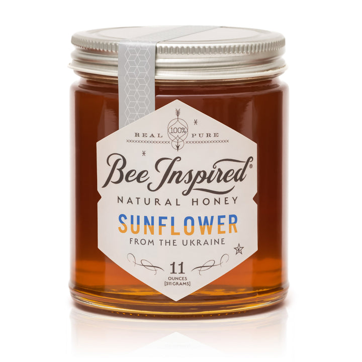 Jar of Bee Inspired sunflower honey on a white background