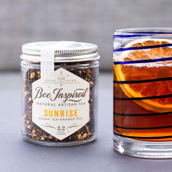 glass of iced Sunrise Assam tea garnished with dried orange slice