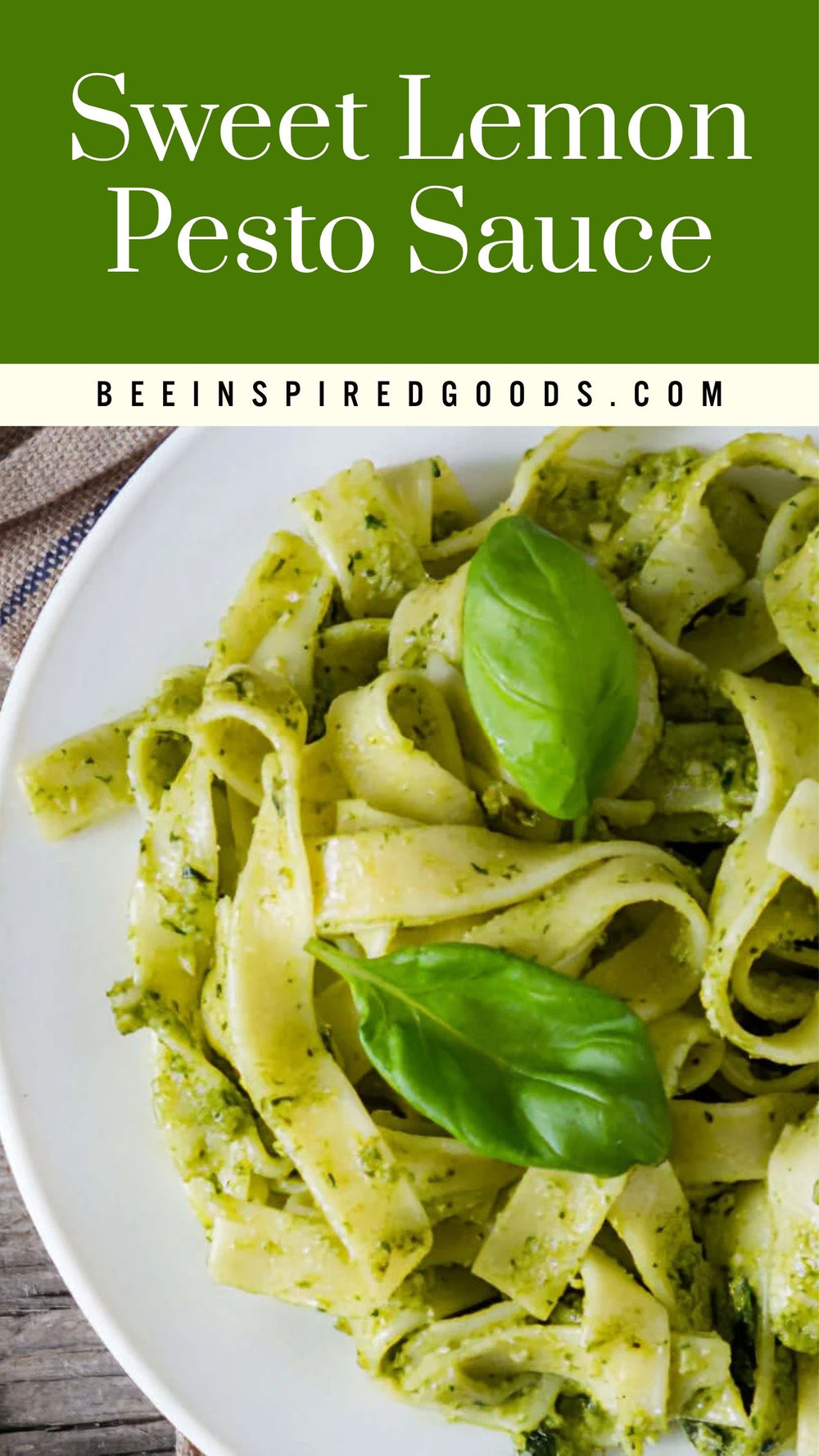 A close-up of a white plate filled with wide pasta coated in green pesto sauce, topped with two fresh basil leaves. Large green text at the top reads 'Sweet Lemon Pesto Sauce' with 'BEEINSPIREDGOODS.
