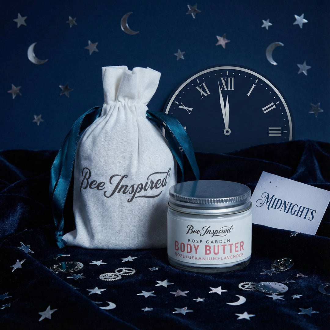 Body butter jar with 'Bee Inspired' label on a dark blue background with stars and moon symbols.