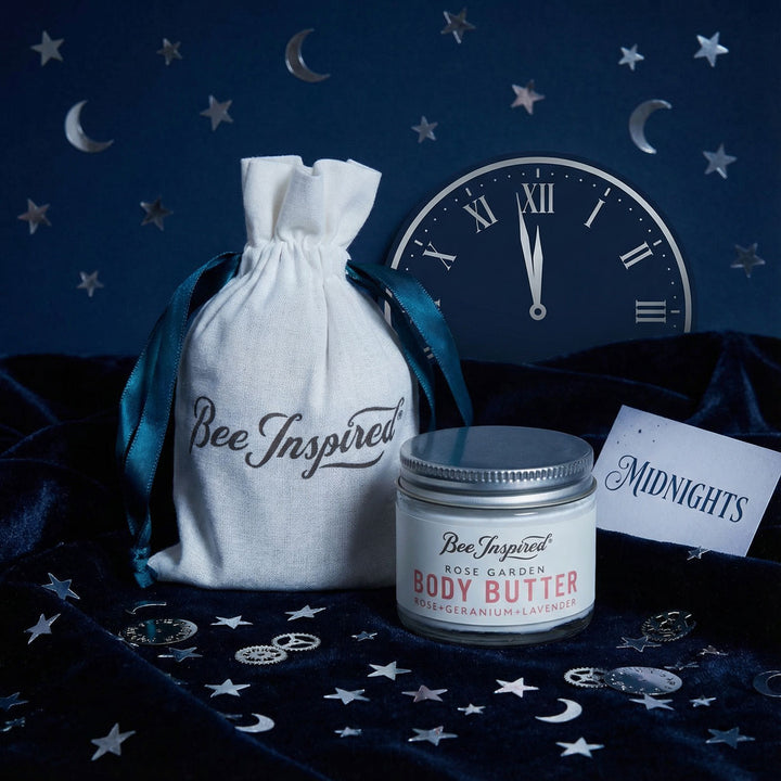 Body butter jar with 'Bee Inspired' label on a dark blue background with stars and moon symbols.