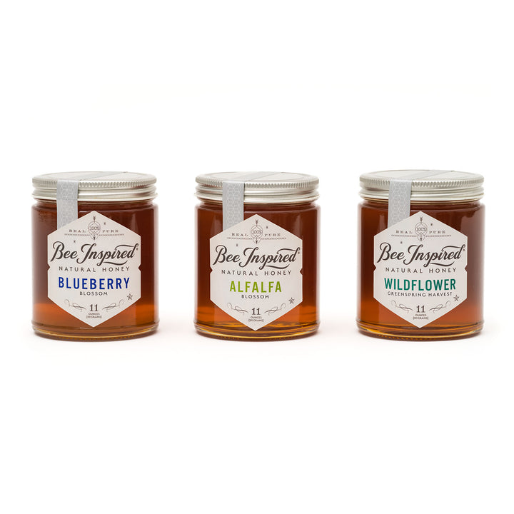 Three jars of Bee Inspired honey in the Allergy Support Honey Gift Set (Blueberry, Alfalfa, and Wildflower) on a white background