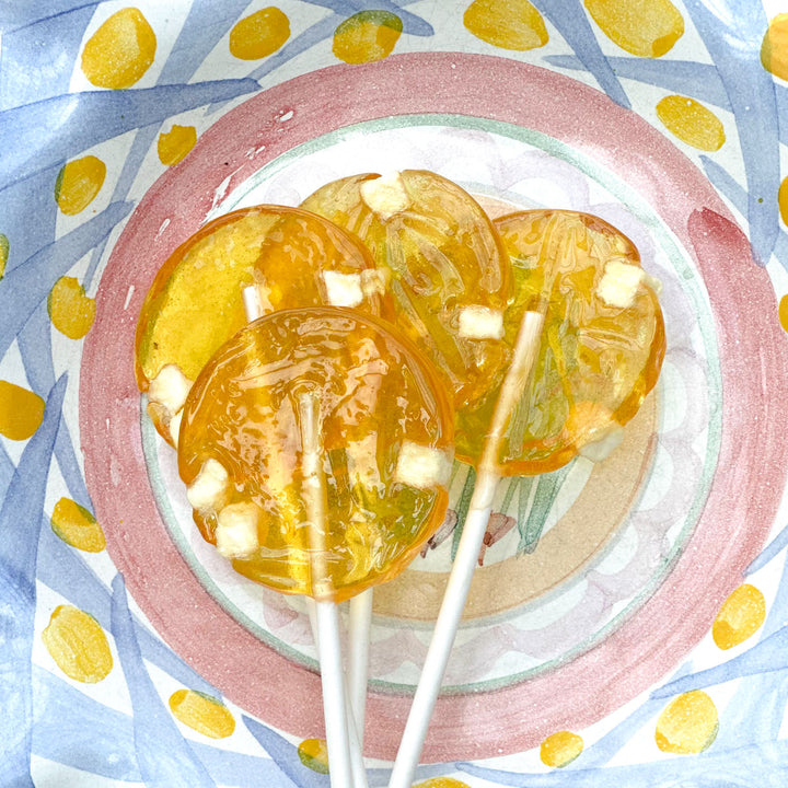 Apple honey lollipops in a painted bowl 