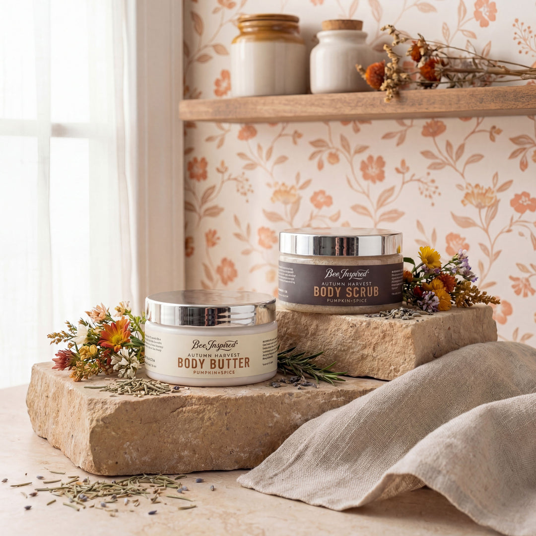 Two jars of body scrub and butter on stone plinths with decorative flowers and a towel in a home setting.