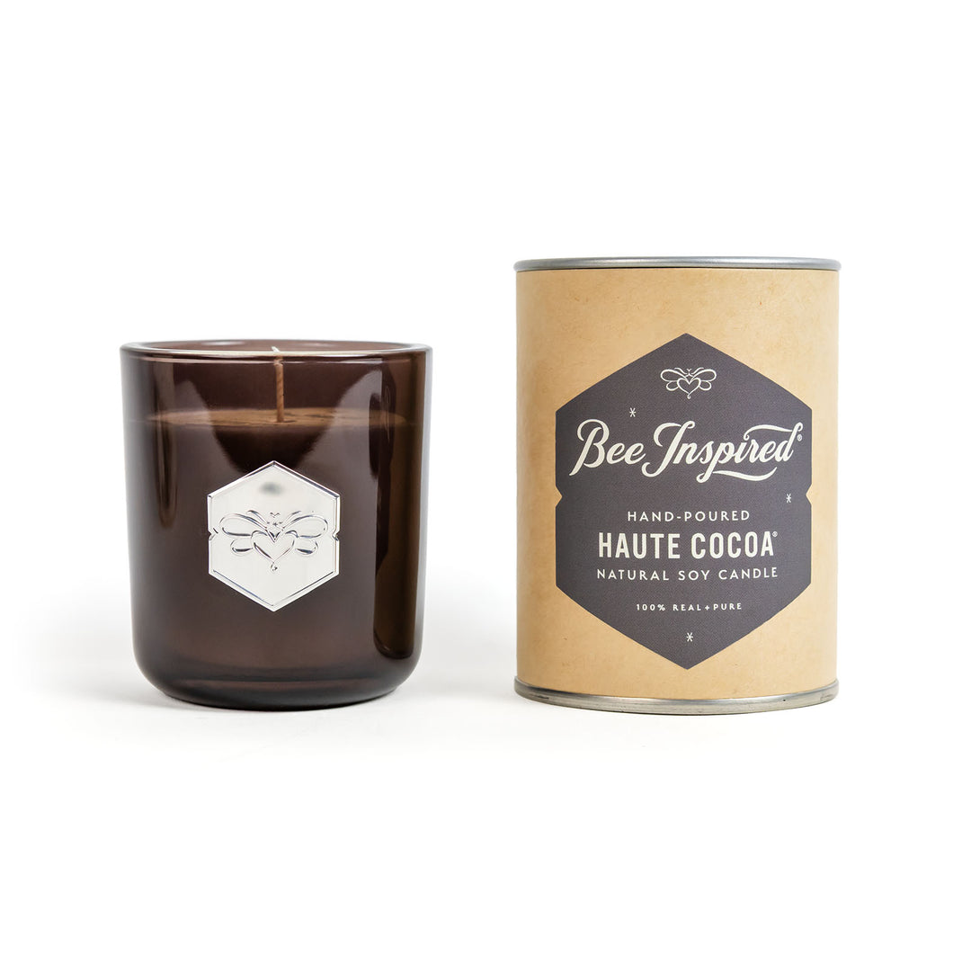 Brown candle with 'Bee Inspired' packaging on a white background