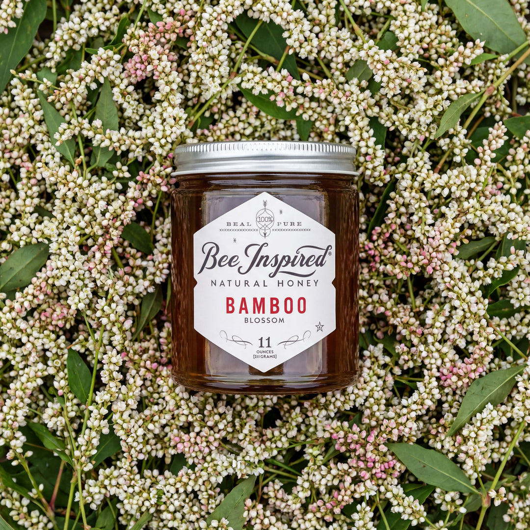 Jar of Bee Inspired Natural Honey Bamboo Blossom on a floral background