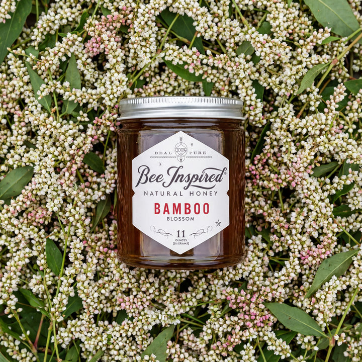 Jar of Bee Inspired Natural Honey Bamboo Blossom on a floral background