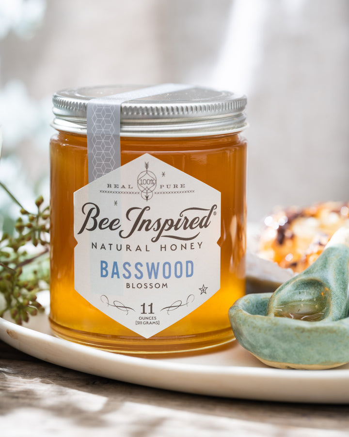 Basswood honey on tray with clay spoon and bowl 