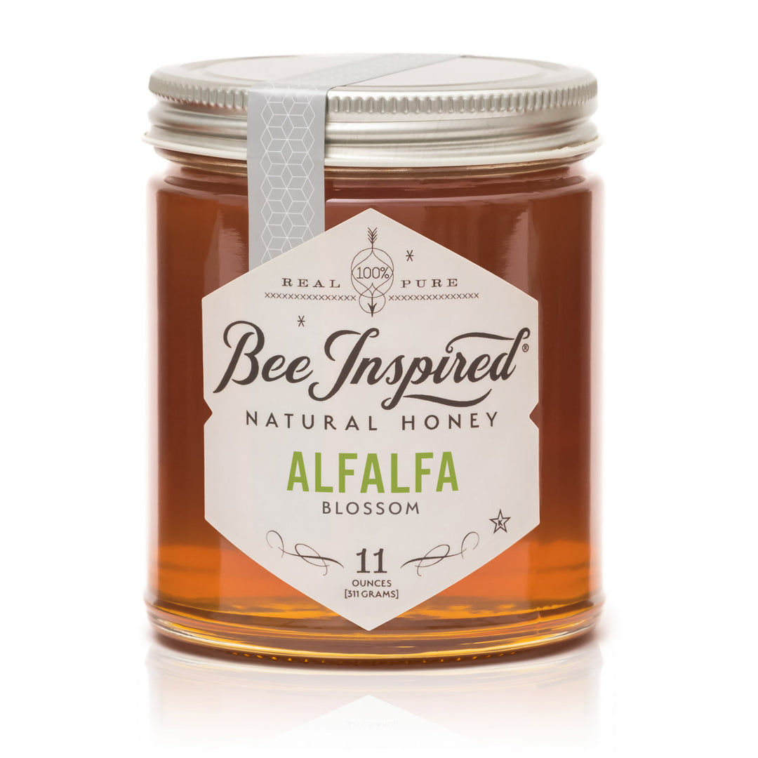 Jar of Bee Inspired natural honey with a white label on a white background