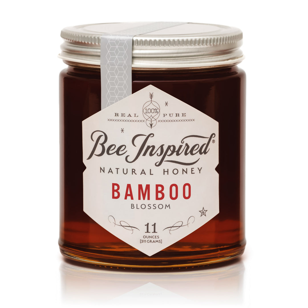 Jar of Bee Inspired Bamboo Blossom honey on a white background