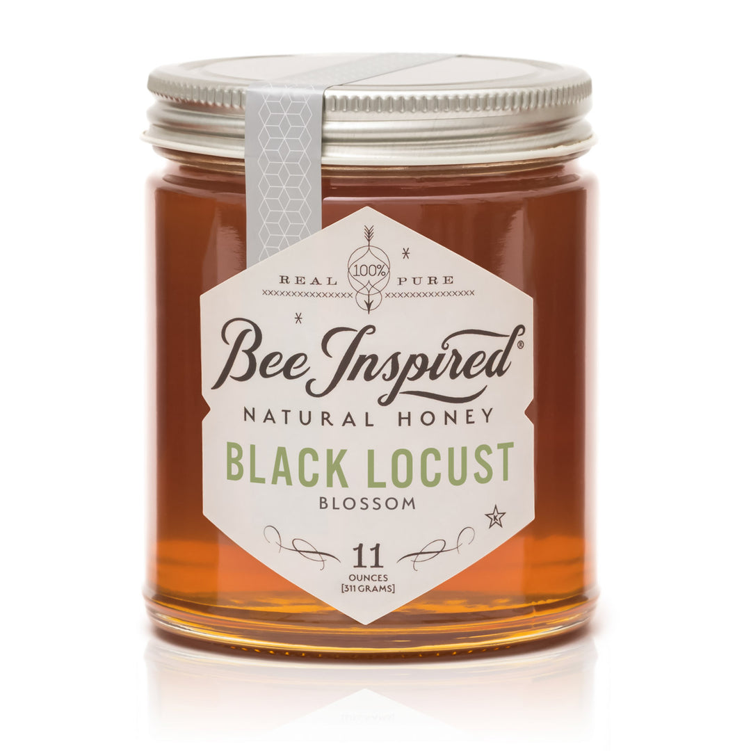 Jar of Bee Inspired Black Locust Blossom honey on a white background