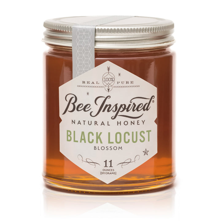 Jar of Bee Inspired Black Locust Blossom honey on a white background