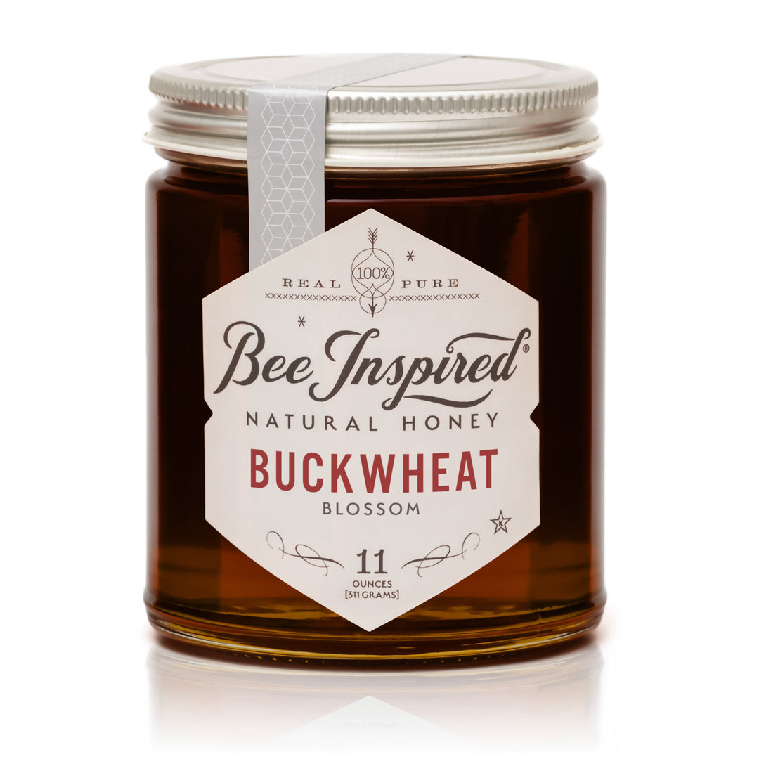 Jar of Bee Inspired natural honey with a label on a white background