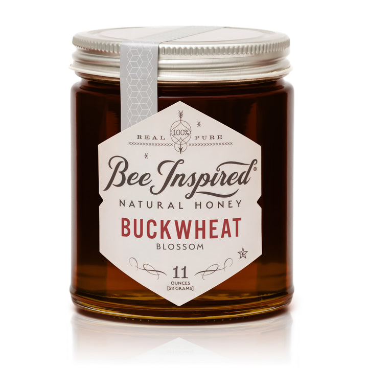 Jar of Bee Inspired natural honey with a label on a white background