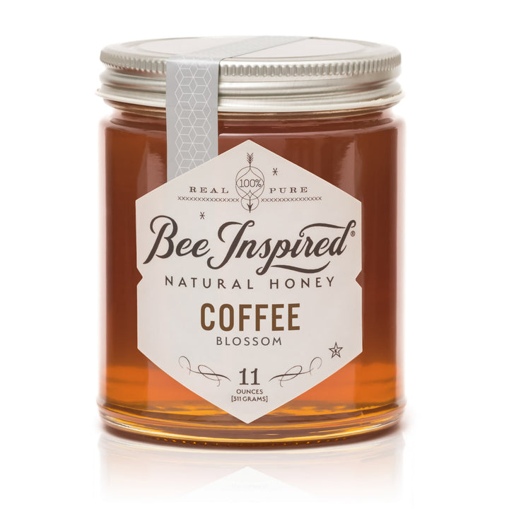 Jar of Bee Inspired Coffee Blossom honey on a white background