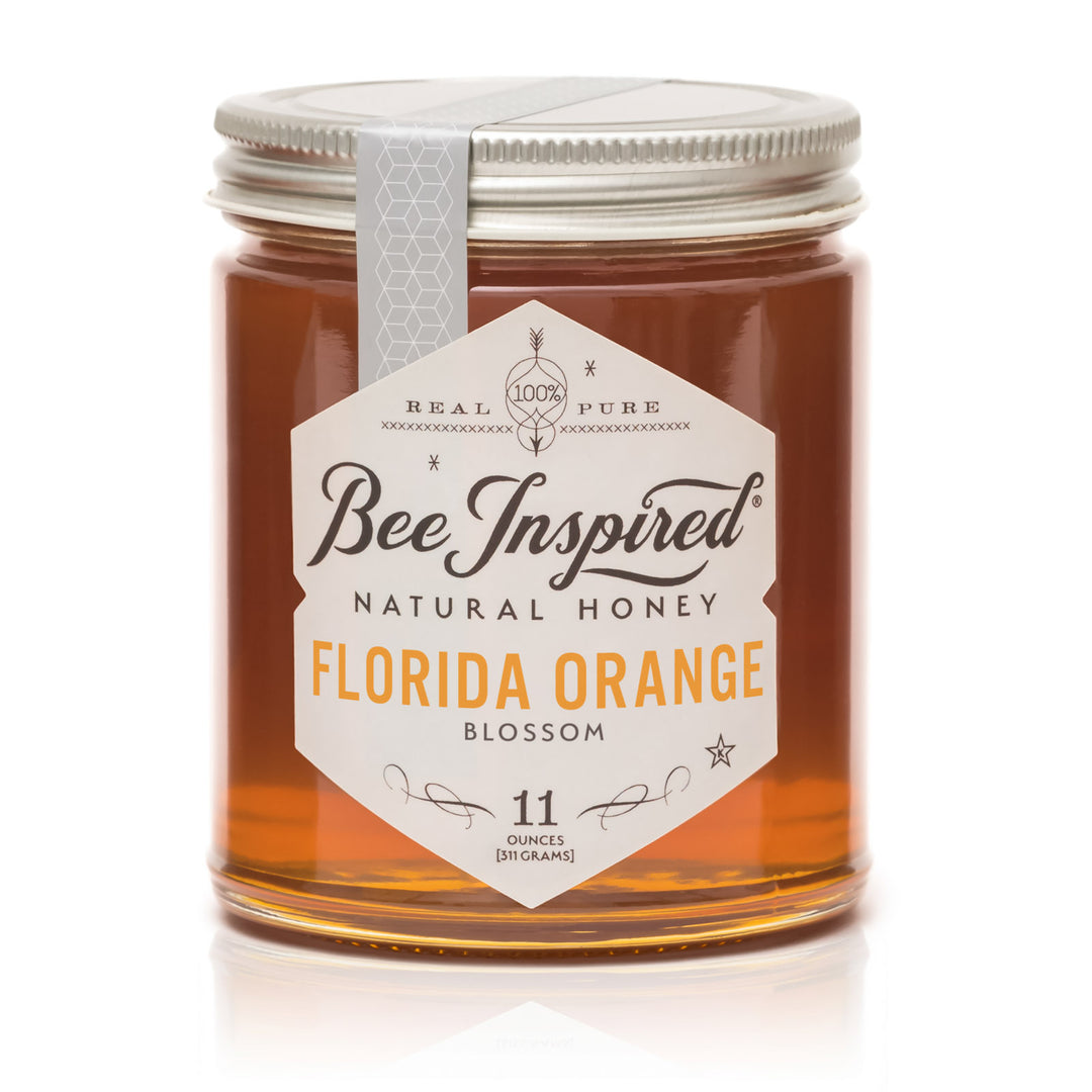 Jar of Bee Inspired Florida Orange Blossom honey on a white background