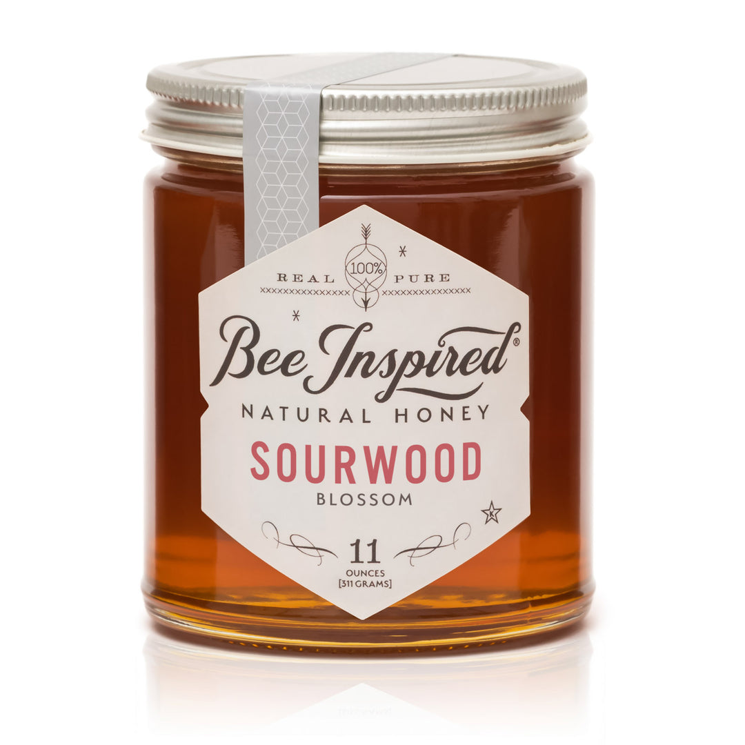 Jar of Bee Inspired natural honey with a white label on a white background