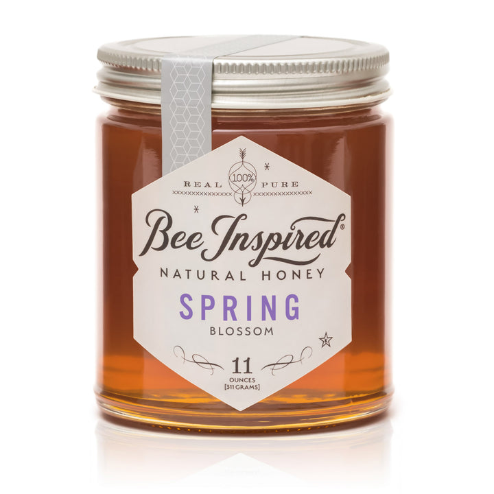 Jar of Bee Inspired natural honey with a white label on a white background