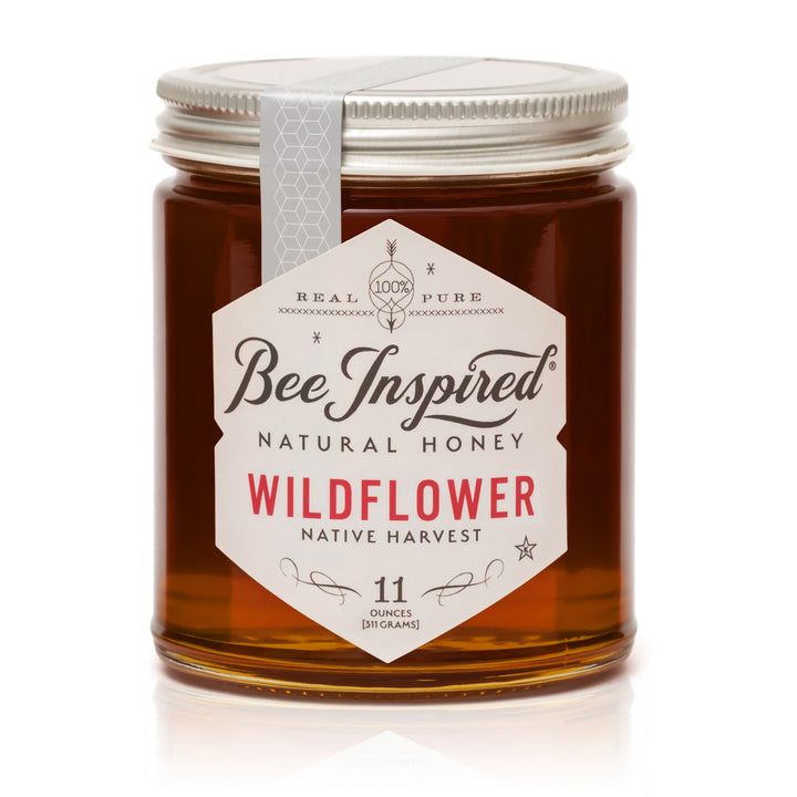 Jar of Bee Inspired Wildflower honey on a white background