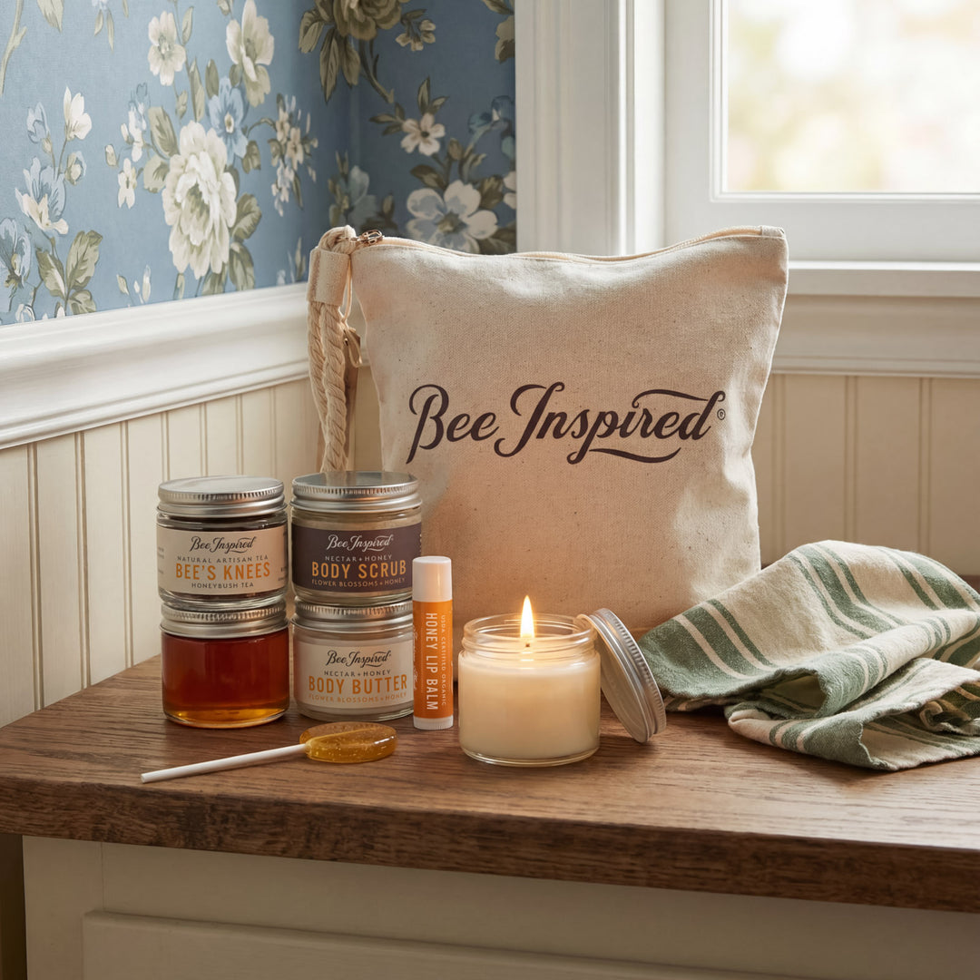 Bee-themed products including candles, oils, and a bag labeled 'Bee Inspired' on a wooden surface.