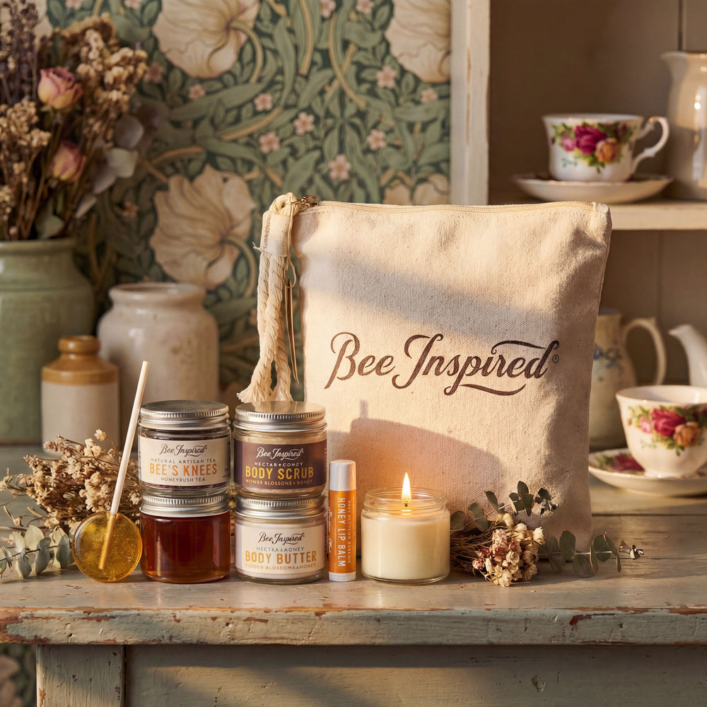 Bee-themed products including candles, scrubs, and a tote bag labeled 'Bee Inspired' on a wooden surface.