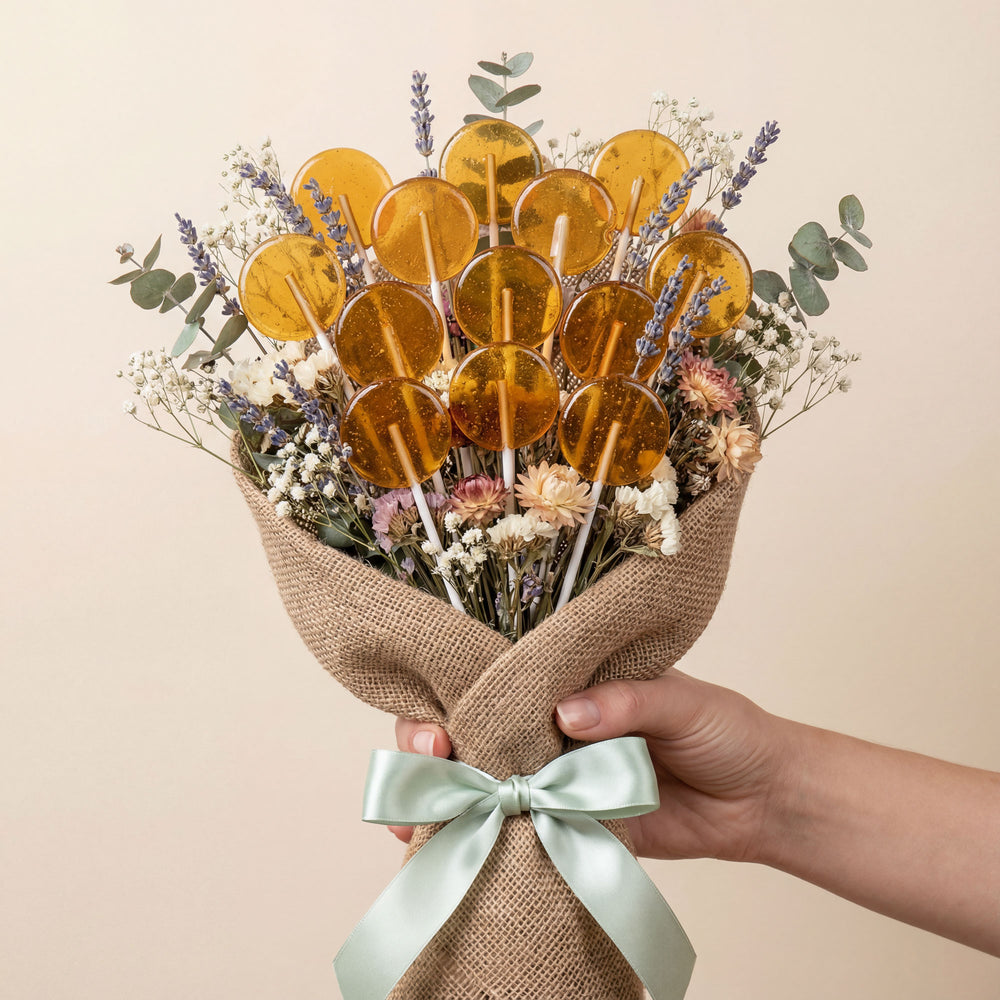 Bouquet of lollipops and flowers held by a hand with a beige background