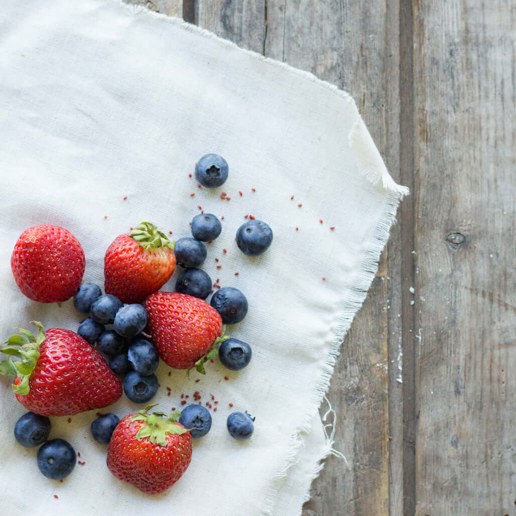 strawberries and blueberries on a white cloth