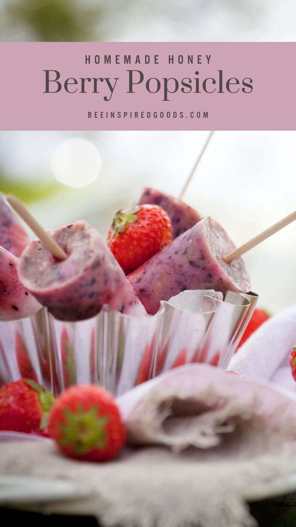 "homemade honey berry popsicles beeinspiredgoods.com" with berry popsicles and strawberries