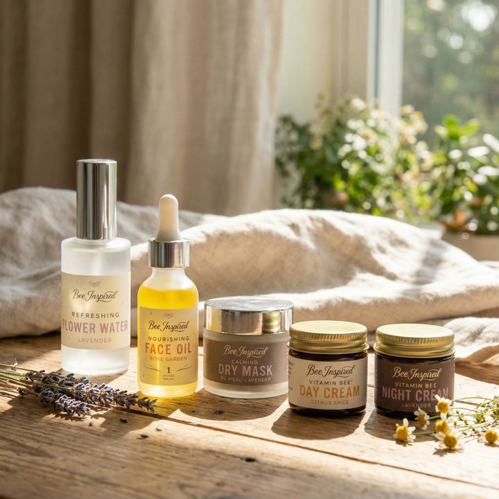 Set of skincare products including bottles and jars on a wooden surface with a natural background.