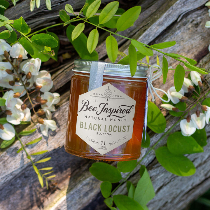 Black Locust honey on wood and flowers 