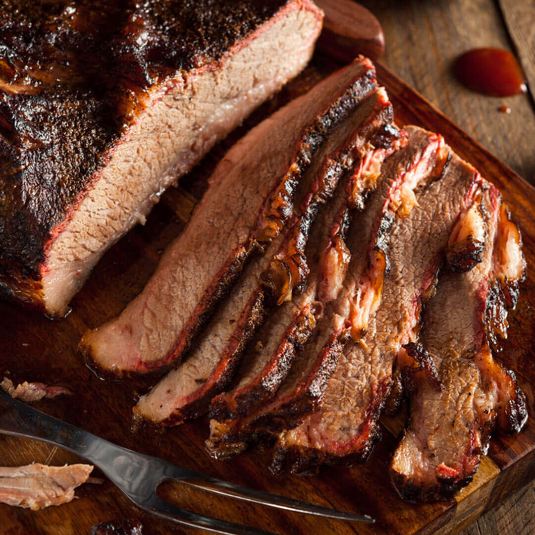 sliced brisket of a wooden cutting board