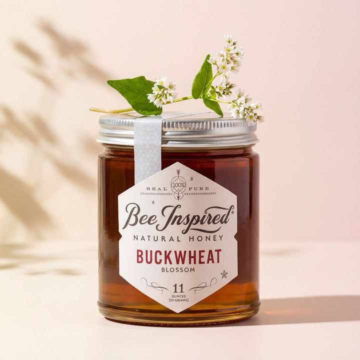 Jar of Bee Inspired natural honey with a label on a beige background