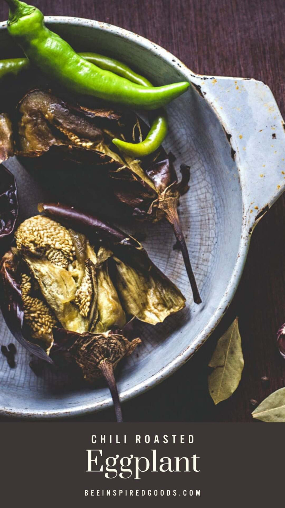 a roasted eggplant with green chilis in a bowl