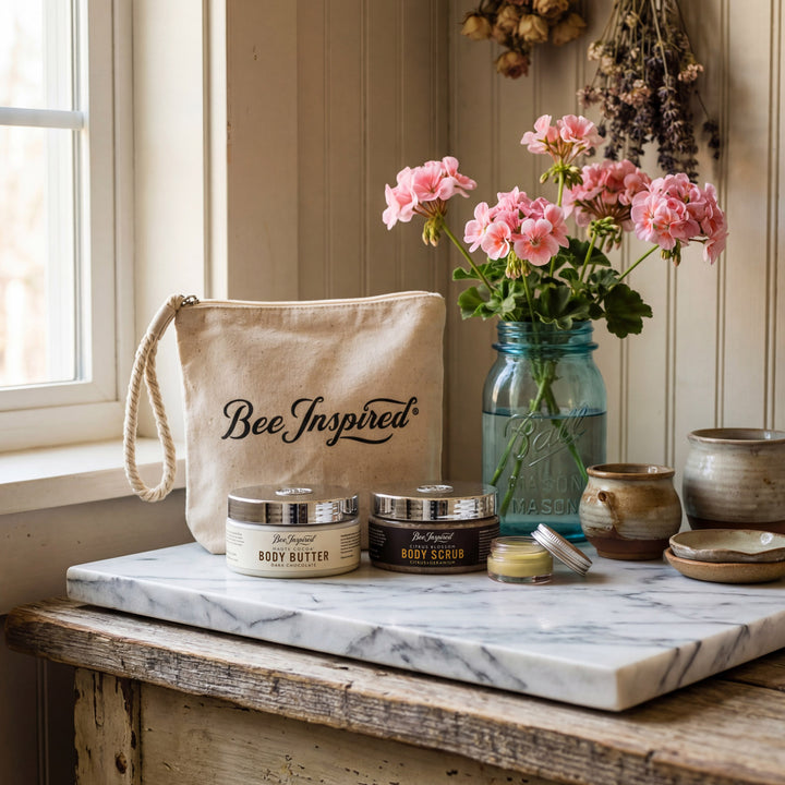 Cosmetic products on a marble surface with 'Bee Inspired' branding, flowers, and rustic decor.