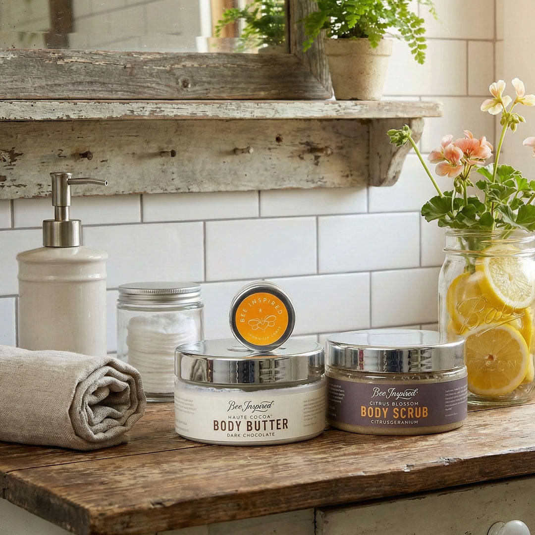 Bee Inspired body care products on a wooden shelf with a mirror and plants in the background.