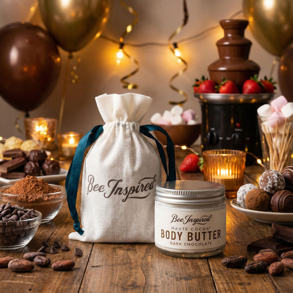 Bee Inspired body butter with a decorative bag on a festive table with chocolate fountain and balloons.
