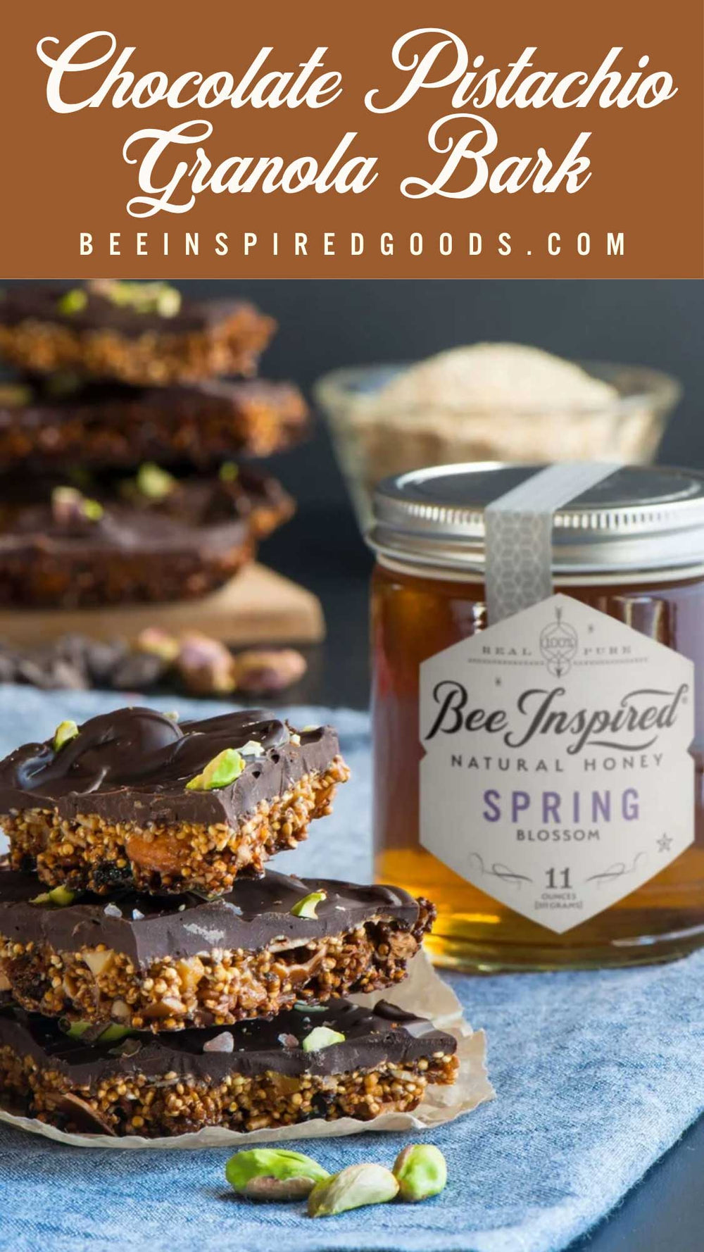 Chocolate pistachio granola bark bars stacked on a plate with pistachio pieces, next to a jar of Bee Inspired Goods Spring Blossom honey, with a text banner at the top reading 'Chocolate Pistachio Granola Bark'.