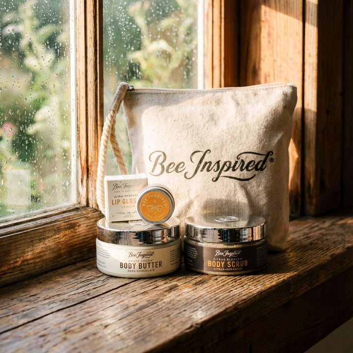 Bee-inspired skincare products on a wooden surface with a 'Bee Inspired' bag in the background.