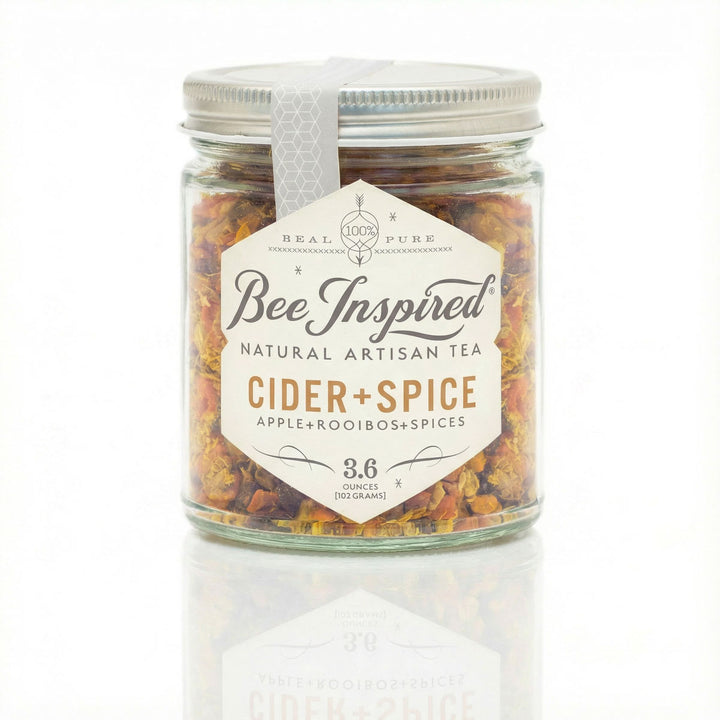 Jar of 'Bee Inspired' natural artisan tea labeled 'Cider + Spice' on a white background