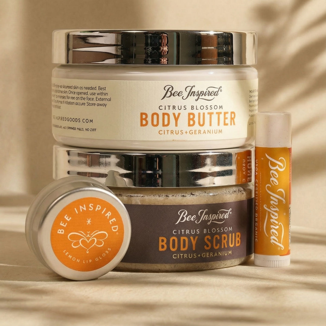 Bee Inspired Citrus Blossom body butter, scrub, and lip balm set on a neutral background